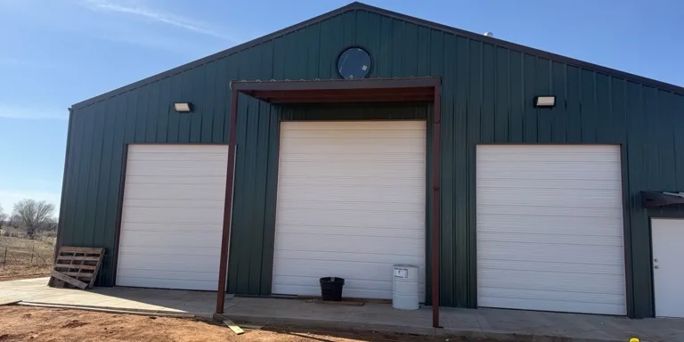 Commercial building with three white overhead garage doors