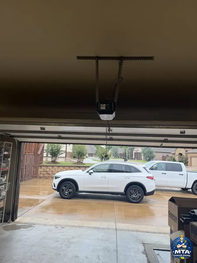 Garage door opener installed above a residential sectional door